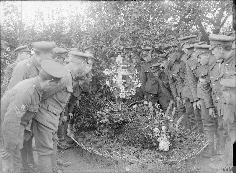 Visit of a deputation from Ireland to the grave of Major William Redford, 6th Battalion, Royal Irish Regiment, at Locre (Loker), 21st September 1917. Northern and Southern Irish troops were present. Imperial War Museum image Q3043