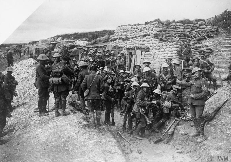 Staff Sergeant (pointing to his right) of the 16th Battalion, Middlesex Regiment (29th Division) with a group of troops of the 1st Battalion, East Lancashire Regiment, parading at the "White City" opposite Hawthorn Ridge for the attack on Beaumont Hamel. Behind them is a party from the 2nd Battalion, Seaforth Highlanders of the 4th Division. Note white cloth carriers "C" letter badges on arms of two soldiers from that group. Imperial War Museum image Q796