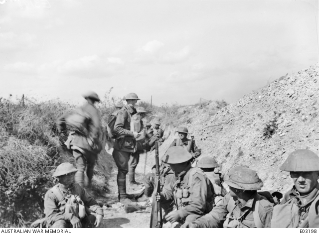 Captain Sullivan MC and Bar MM, Officer Commanding A Company, 21st Battalion, in Elsa Trench with some of his men, immediately before going out to participate in the attack on Mont St Quentin, at 1.30 pm, on 1 September 1918. It was with this renewed assault that the enemy resistance was broken and the whole position of Mont St Quentin won. Australian War Memorial image EO3198