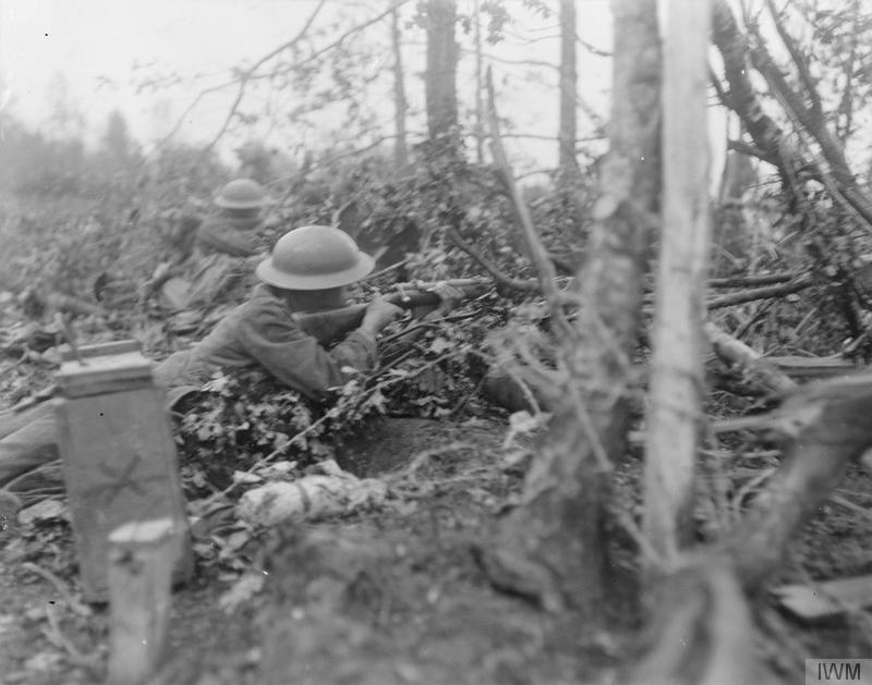 Battle of Tardenois. Infantry men of the 62nd Division looking out for the enemy in the Bois de Reims. Imperial War Museum image Q11089