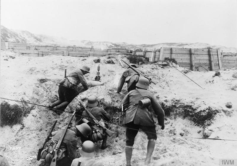 A German minenwerfer (trench mortar) section in action in the dunes on the Flanders Coast, July 1917. Imperial War Museum image Q50665